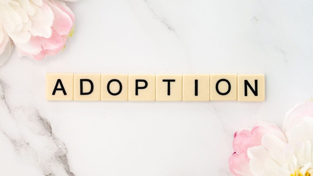 Adoption spelled out in letter tiles